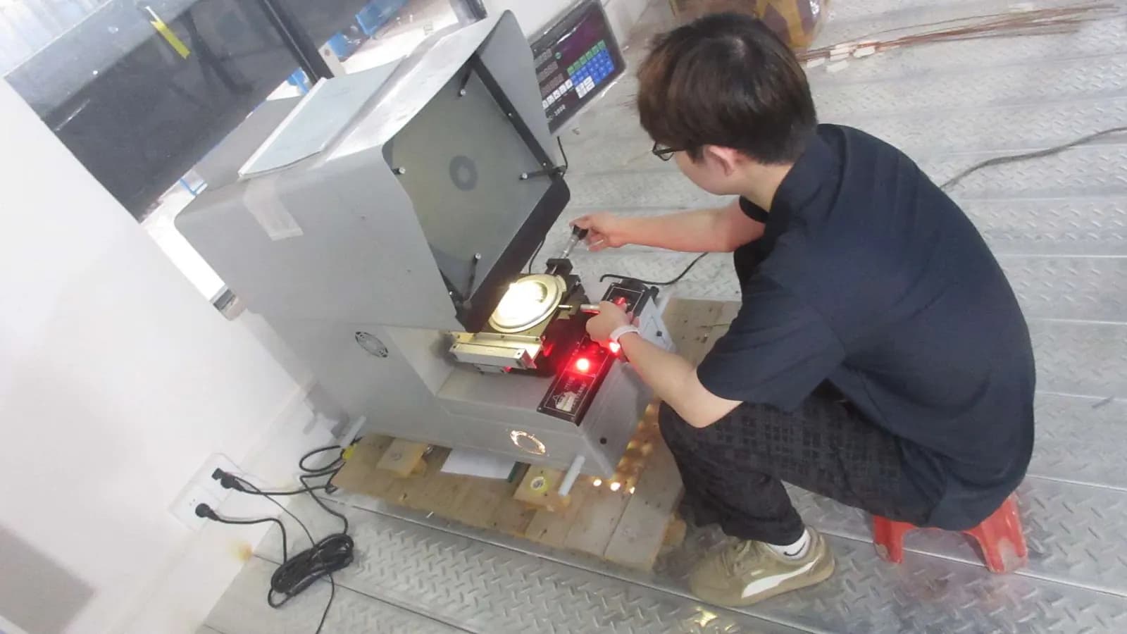 Operator adjusting a cable machine on the production floor