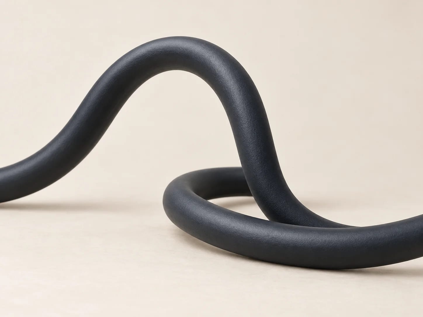 A thick round-sheathed flexible cable curving across a plain surface. Orientation image; verified values are on each product record.